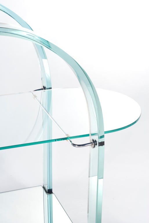 Bar cart of glass and mirror. Beautifully curved arms with a glass tableau and mirrored bottom shelf. Stamped Fiam.
