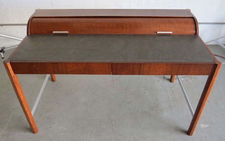 A unique vintage mid century modern roll top desk by the Hekman Furniture Company of Grand Rapids, Michigan. Hekman Furniture was funded in 1922 and become part of the Howard Miller Company in 1983. The company is still in business but this desk