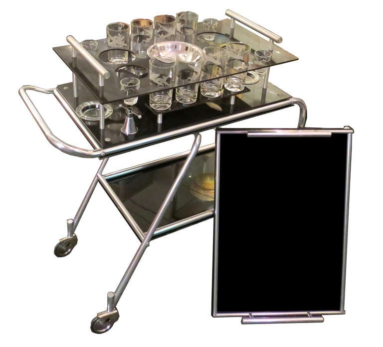 This streamline American Art Deco rolling cart was developed by Frantz Industries in 1938 for use on the DC-3, the legendary airplane that revolutionized air travel.  It was the first aircraft to have an in-flight kitchen.  This is the most complete