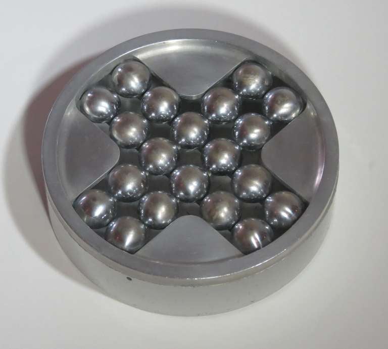 This unusual ashtray was made in 1963 in the studio of George Ciancimino (1928-). Hand crafted and useful for cigar, cigarette or pipe smokers, and the base of the ashtray is made of Aluminum. The balls are half round and individually set on a