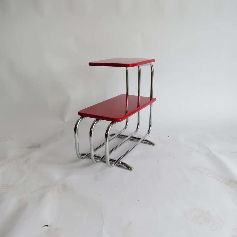 This American art deco streamline table was designed by Alfons Bach (1904-1999) for Lloyd Chromium Furniture, The Lloyd Manufacturing Company Menominee, Michigan. It is finished in its original red lacquer. The table is known as “T-57-A Table”
