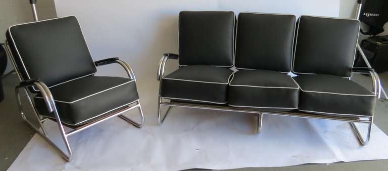 Kem Weber (1889-1963) designed this chair and settee davenport for Lloyd Manufacturing Company, Menominee, Michigan in 1938, the only year they were produced. The frames are of chrome plated 1” tubular steel with a veneered bottom board and black