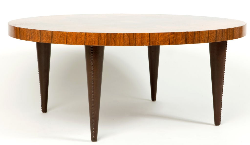Gilbert Rohde (1894-1944) designed this three foot in diameter coffee table for the Herman Miller Furniture Company, Zeeland, Michigan, where it was offered as their No. 4121 Coffee Table in the supplement to their Fall 1940 catalog.  The table top