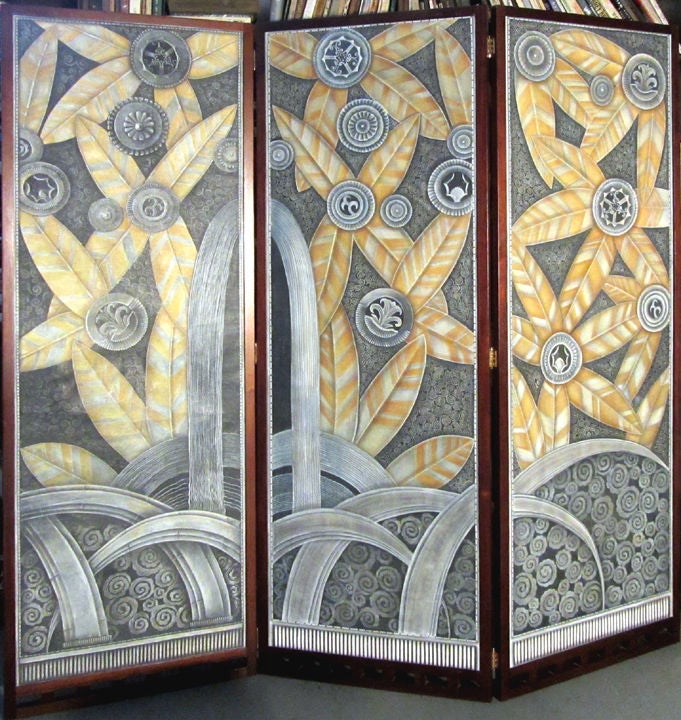 The three hand painted on canvas American art deco panels in this folding screen came from a 1920’s movie theatre.  The previous owner had them professionally mounted to form the hinged screen.  The panels are reminiscent of Edgar Brandt’s famous