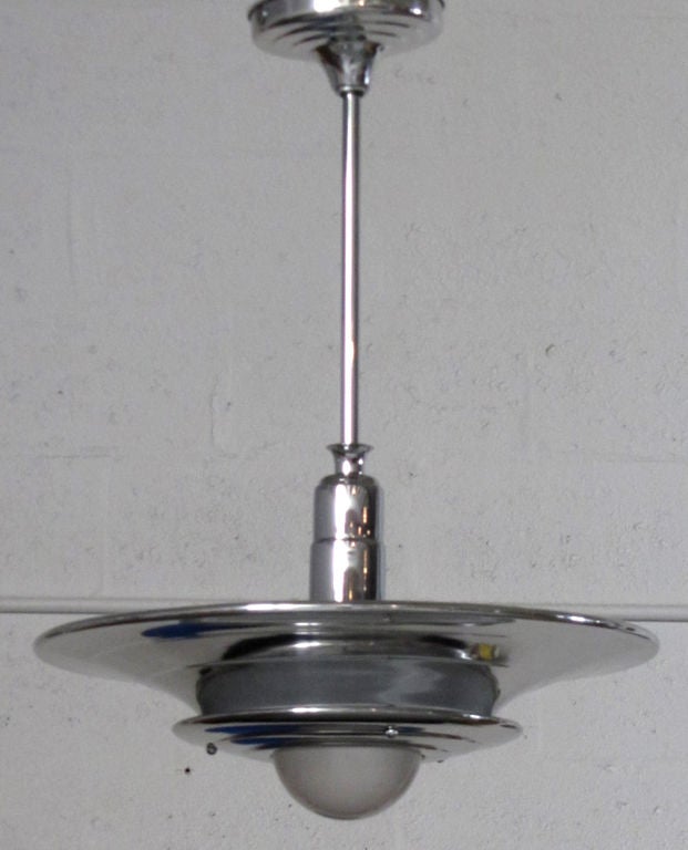 These two American art deco ceiling lamps resembling flying saucers were made in the 1930’s by the Miller Company of Meriden, Connecticut.  The ceiling lights consist of two graduated size aluminum shades separated so that light can emit from the