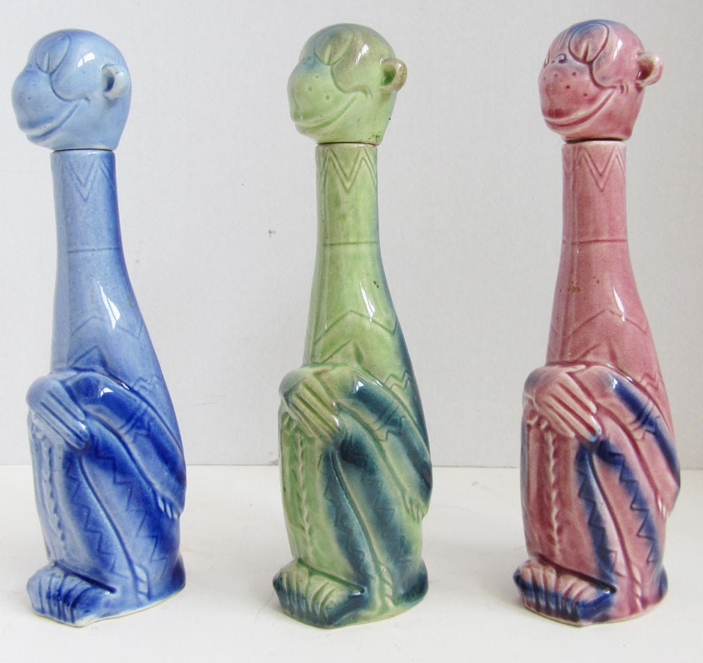 These three smiling and wide eyed German art deco ceramic decanters are from the 1930’s . If Dr. Seuss had designed monkey decanters (he didn’t) they would look like this trio. In pink, blue, and green glaze with airbrush highlights, the fantastic