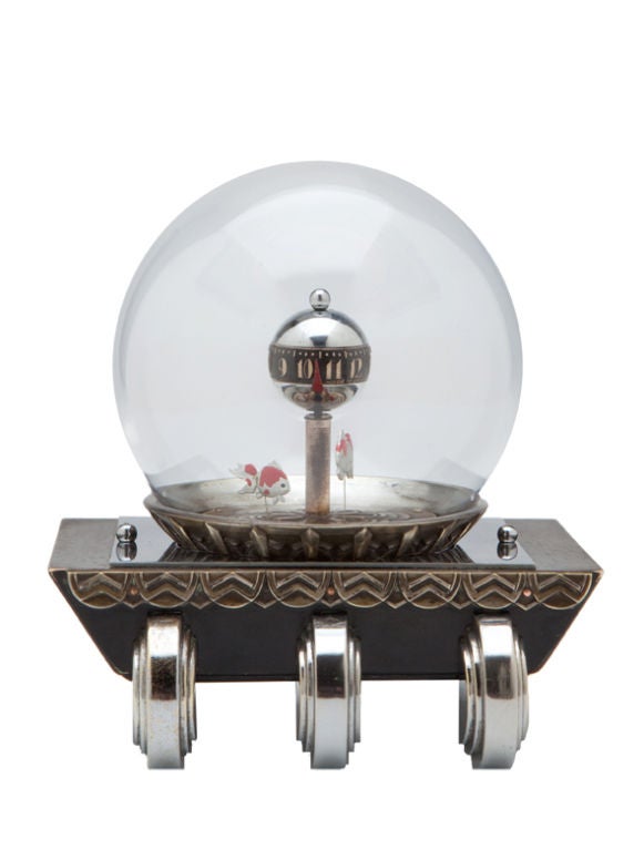 A wonderful example of Japanese art deco design. This clock has six feet similar to a Dominique design and a black base with geometric frieze. The clock, which rests under a glass dome, has deco numbers and a rotating shaft, a red arrow which points