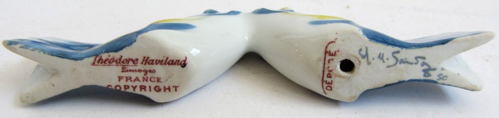 This set of nine whimsical French art deco “Kissing Fish” knife rests was designed in 1916 by Edouard Marcel Sandoz (1881 – 1971) for the Haviland Limoges Porcelain Company.  The set consists of four blue rests, three yellow rests and two green