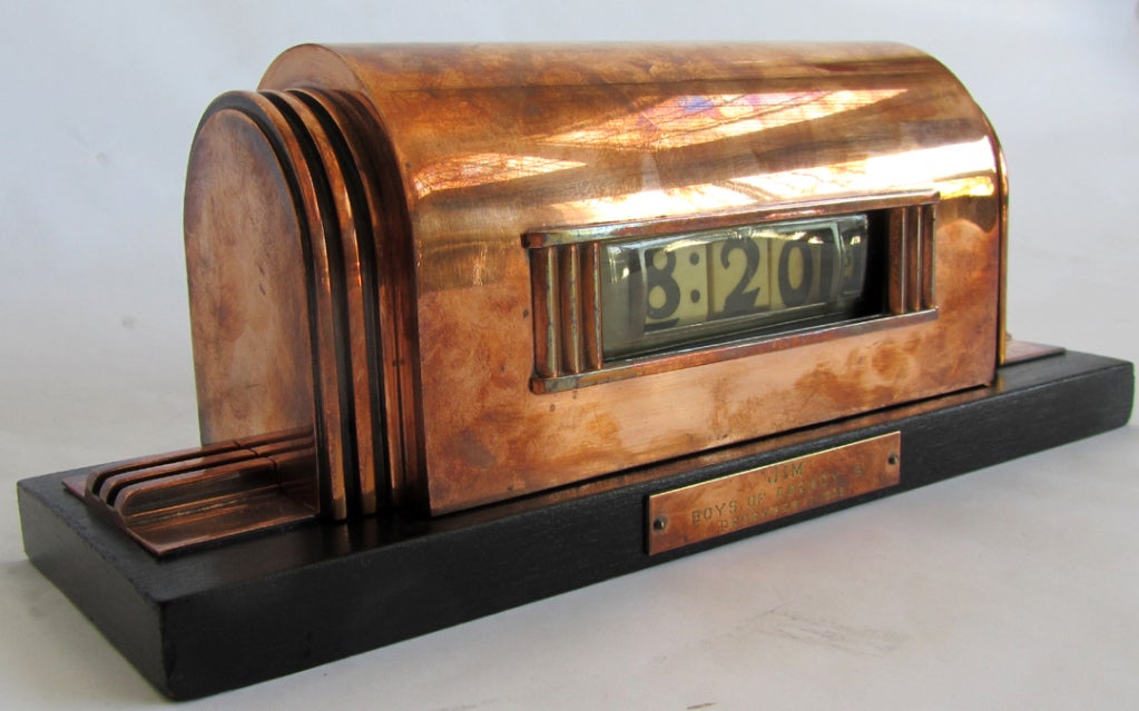 This early and rare American art deco clock was designed ca 1935 by  Karl Emmanuel Martin (KEM)  Weber for Lawson Time Inc., Los Angeles, California. The copper clock, which rests on a ebonized wood base, has a dome shaped body with three “speed”