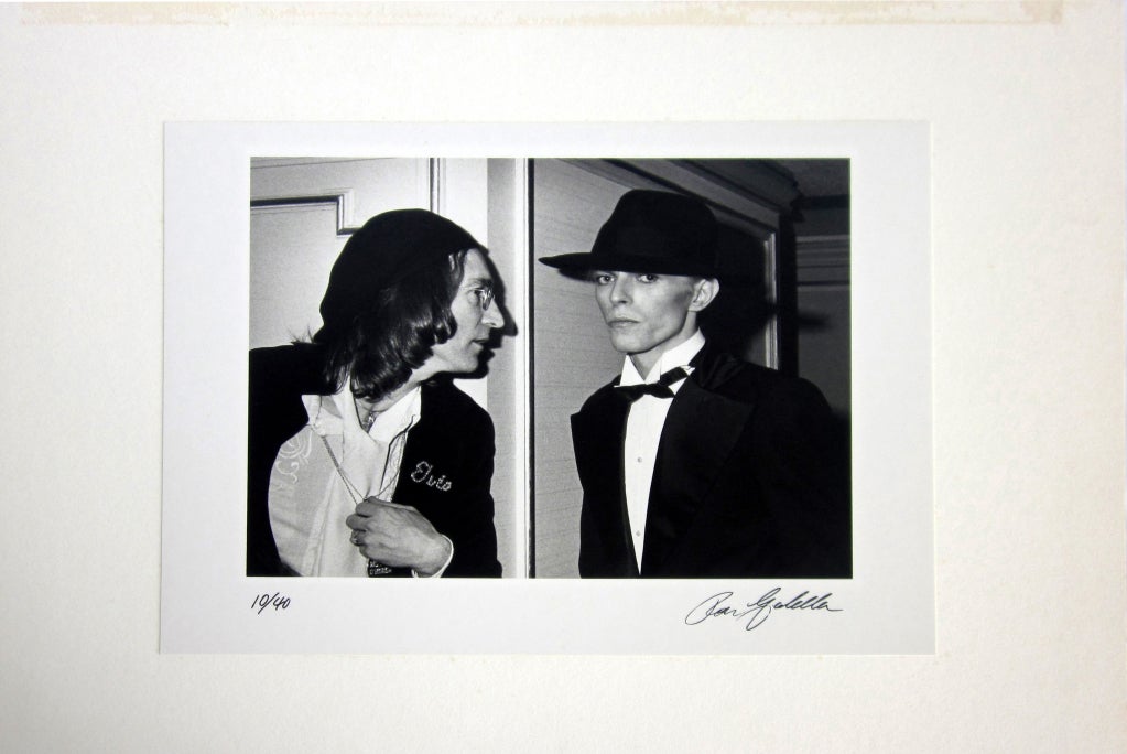 A wonderful vintage Ron Galella black and white photographic print of John Lennon and David Bowie at a 17th Annual Grammy Awards after-party.  Bowie and Lennon were both part of the “Young Americans”.  This is a very famous image and has been used