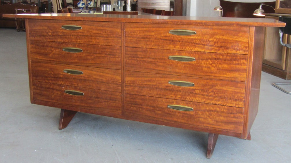 This American mid-century modern design eight drawer dresser was designed by George Nakashima (1905 -1990) ca 1950 for his Origins Line, produced by the Widdicomb Furniture company, Grand Rapids, Michigan. The chest is constructed with east Indian