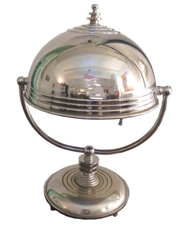 This American art deco nickel plated desk lamp was manufactured in the 1930’s by the Markel Corporation of Buffalo, New York. The “speed” era is represented in the lamp with raised “speed” lines on the bottom and stepped rings on the top of the