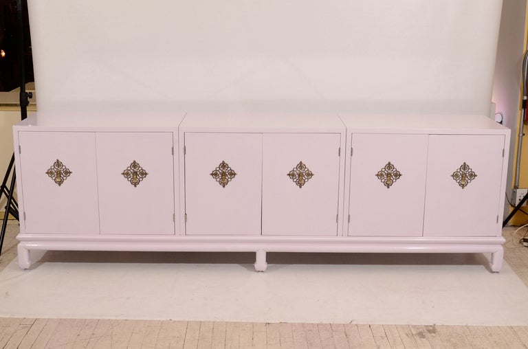 Glamorous credenza designed by Renzo Rutili. Re-lacquered in a beautiful light lavender and accented with polished brass hardware. Wonderful! Located in Las Venus at ABC Home, 646-602-3519.