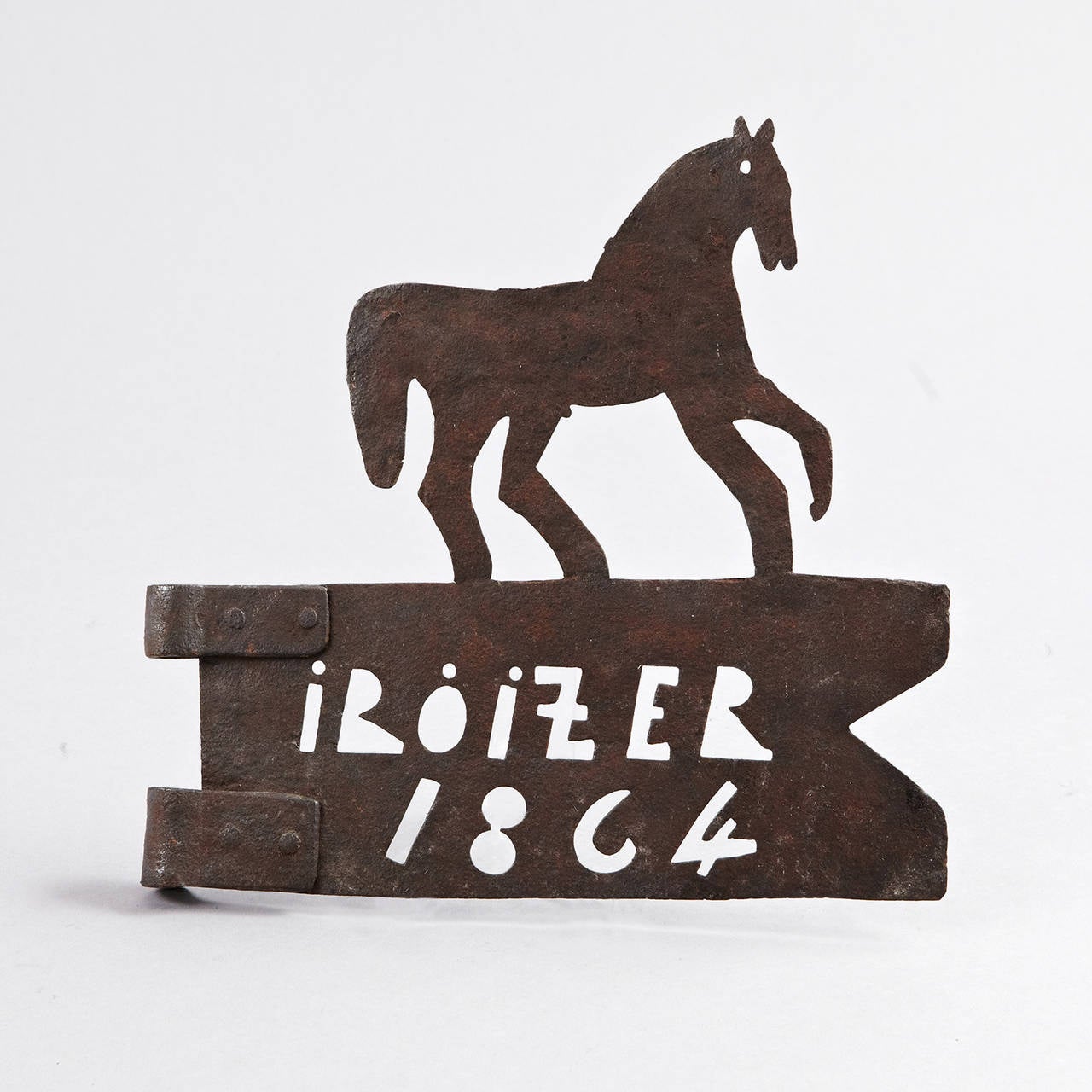 European metal (iron) weathervane of a banner on which a figure of a horse stands. The word "Iroizer" and the date "1864" are cut out of the metal. A hinge is attached to one end. Dimensions 12" x 12" x 1".