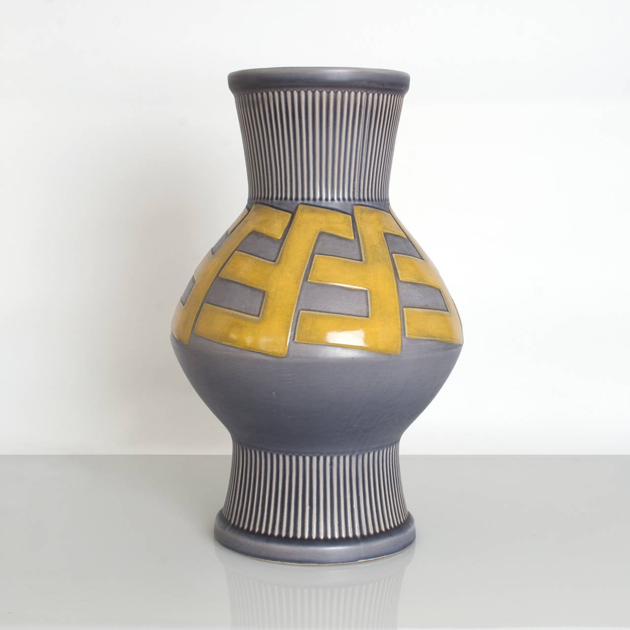 Huge Swedish Art Deco ceramic vase with a raised bold pattern in a golden glaze on a grayish blue background. Designed by artist Ewald Dahlskog for Bo Fajans circa 1930's. Height 17.5