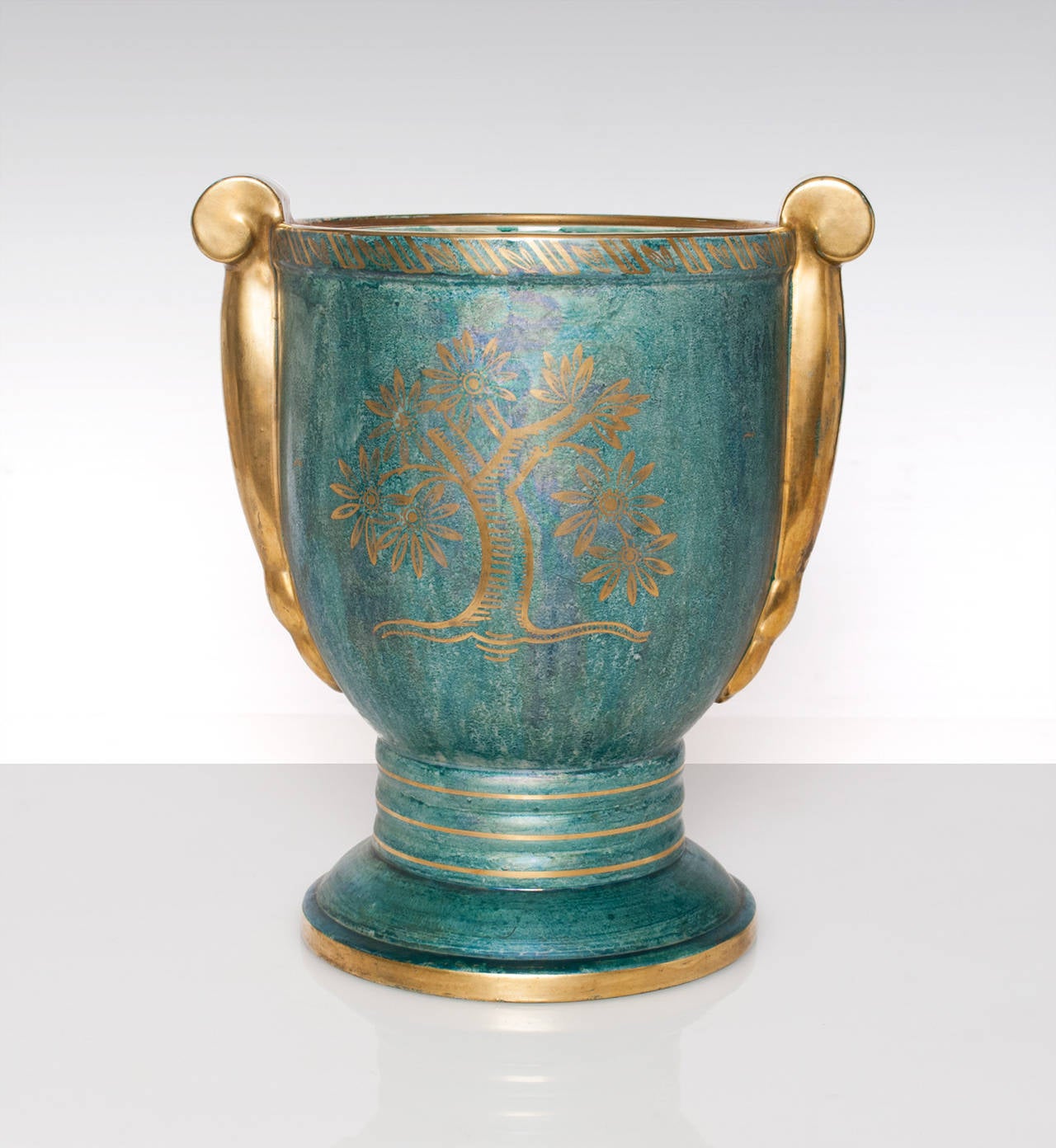 Large Swedish Art Deco, hand decorated ceramic vase with handles from Gustavsberg. Designed and signed by Josef Ekberg, 1920's, in a blue-green luster glaze with details in gold.
 
Height 12", Width: 10.5", Depth: 8"