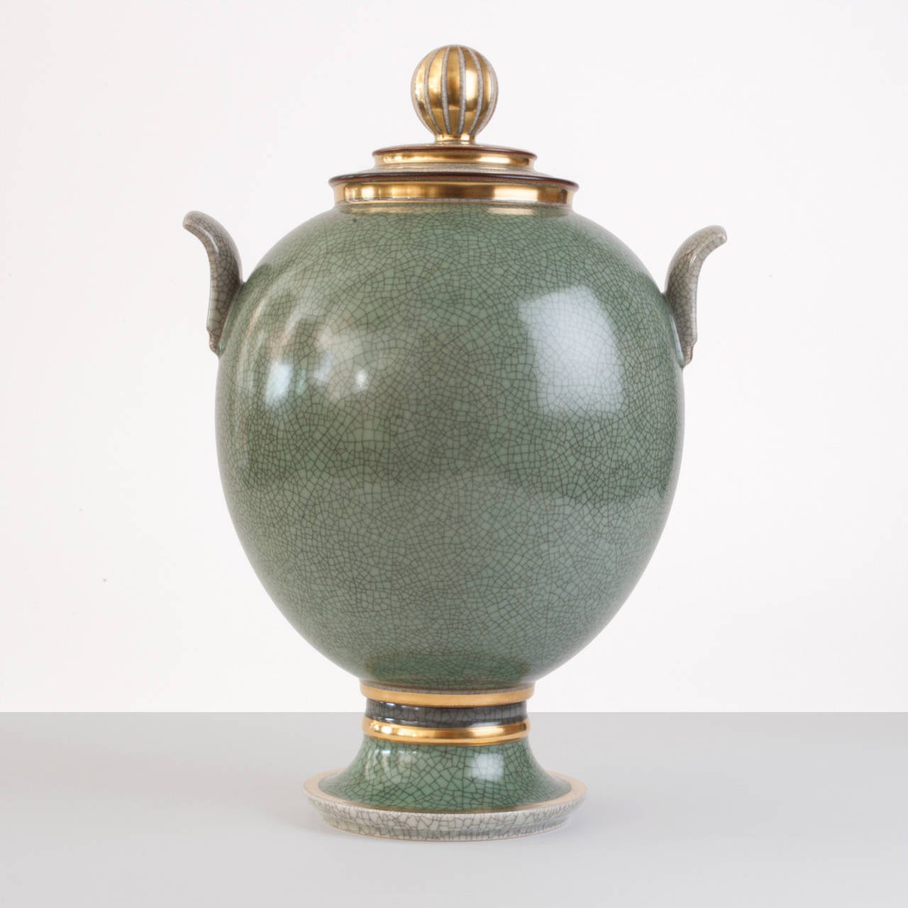 Very large Danish Art Deco Royal Copenhagen gilt & craquelure ceramic jar with lid, in a green glaze detailed with gold. Height: 16