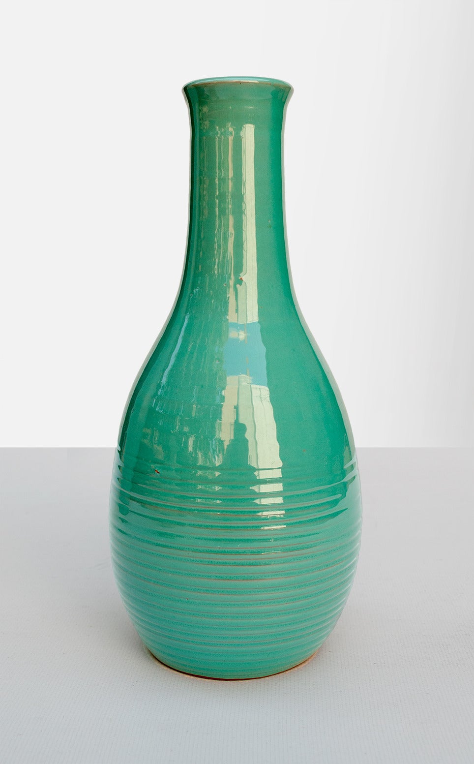 A Scandinavian Modern, Swedish art deco ceramic vase in a shiny green glaze designed by Ewald Dahlskog, for Bo Fajans, circa 1930's. Height: 11.25", Diameter: 5.25".