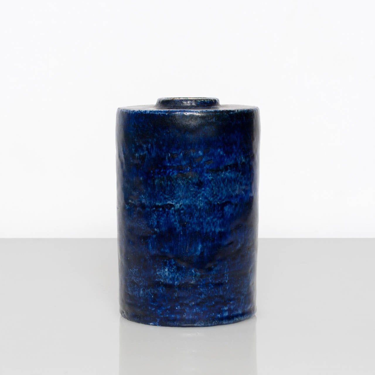 A Swedish art deco unique ceramic vases by Gertrud Lonegren for Rorstrand circa 1938-1942. Cylindrical in form with raised opening and a mottled cobalt blue glaze. H: 7.5