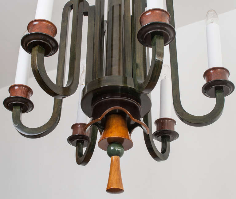 20th Century Swedish Art Deco chandelier in stained and polished birch wood.