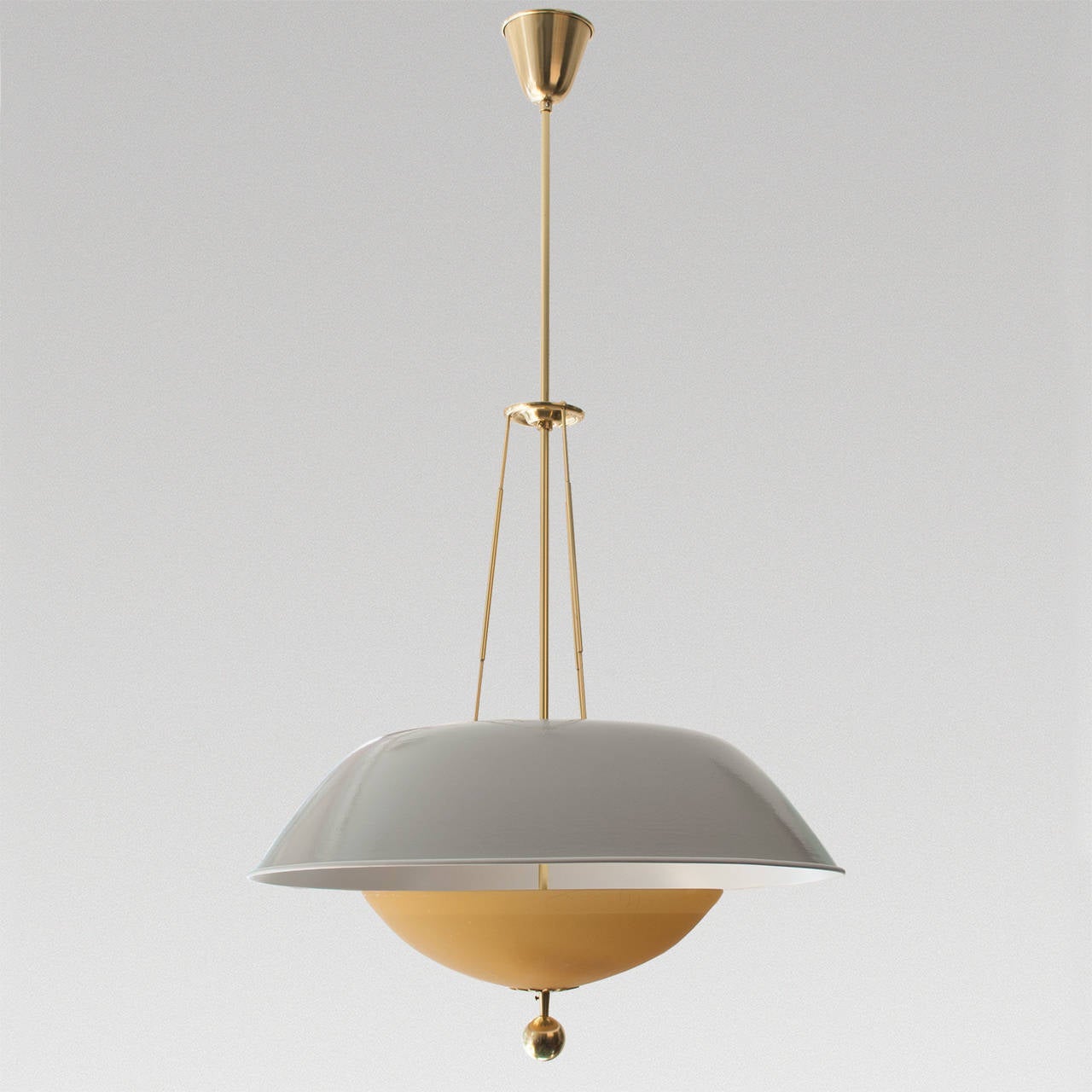 Swedish Mid-Century pendant with gray lacquered metal shade and pale amber glass shade. The metal shade is suspended with three brass rods which join at an adjustable notched brass plate on the main stem and terminate at a decorative brass ring