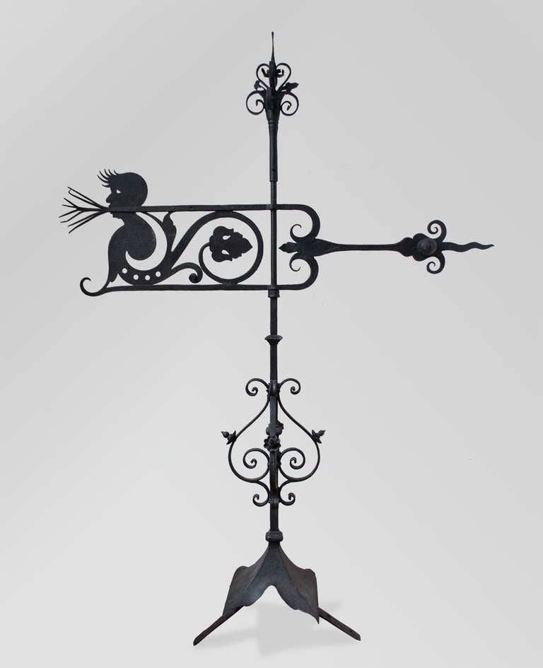 A charming Swedish hand wrought iron very early 20th century weather vane with a man's head silhouette along with a leaf. Weather vane has its original mounting braces and it's pointer is functioning perfectly. Total height with 2 braces: 55