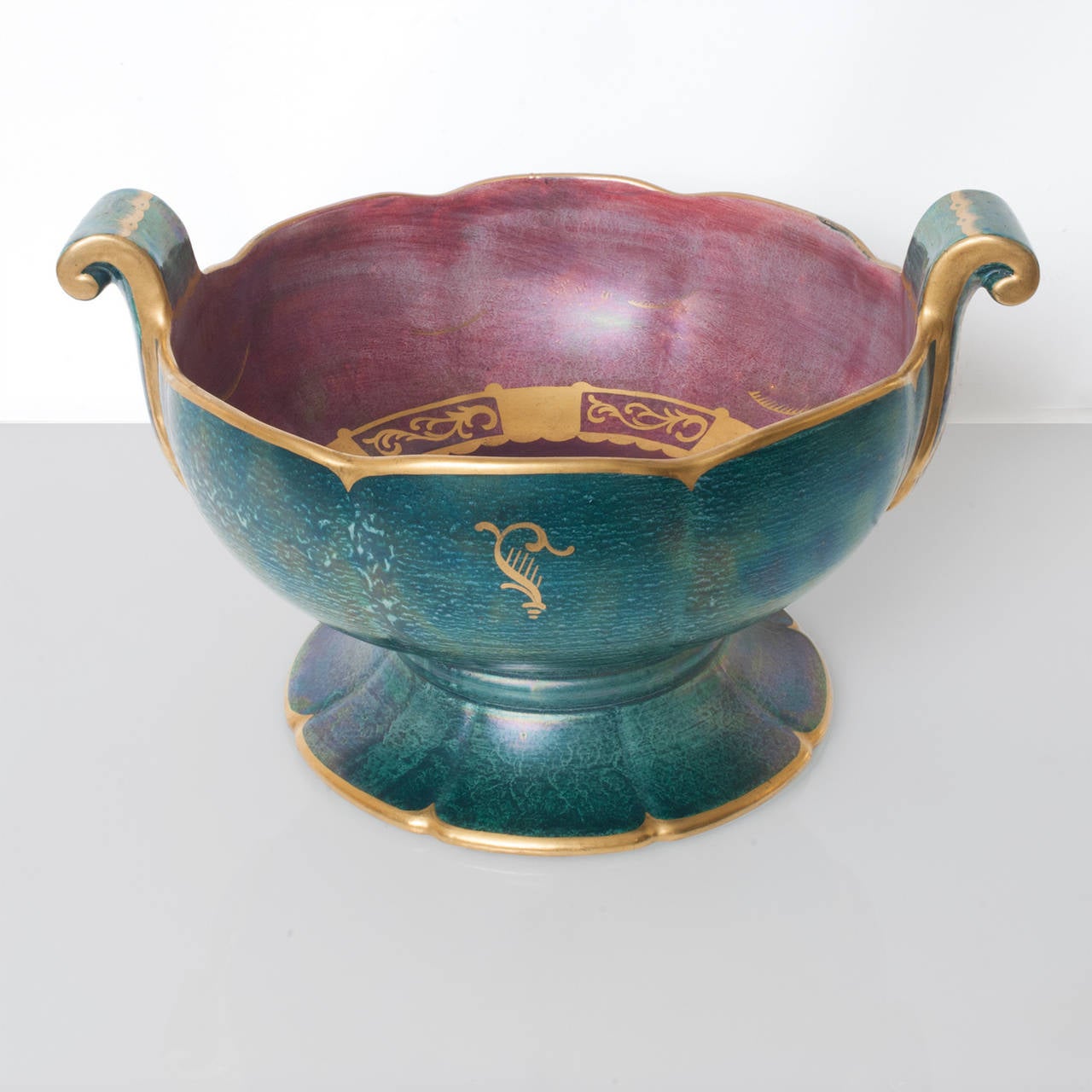 A large Scandinavian Modern luster glazed ceramic bowl with hand decorations in gold. Bowl has 2 handles with are detailed with acanthus leaves and is signed and dated 1928.
Diameter 14", height: 8.25".