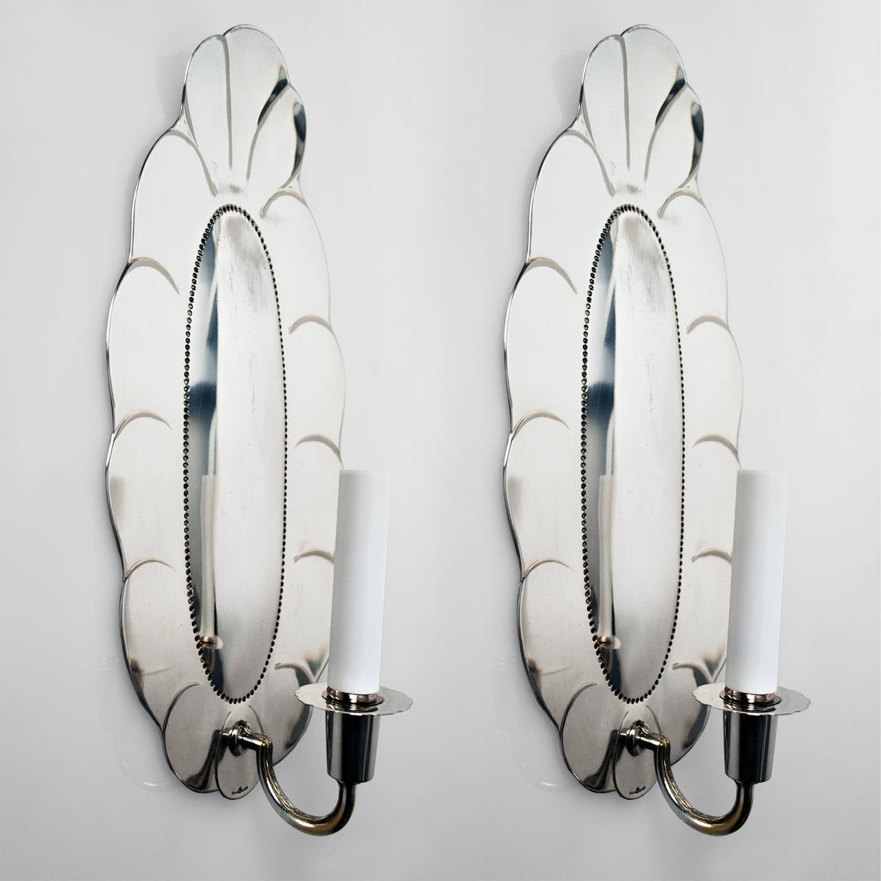 Large pair of Swedish art deco silver plated sconces from Jacob Ängman for GAB, Stockholm. The sconces have been newly polished, lacquered and electrified with candelabra sockets. There is were to backplates with silver loss. Height 15