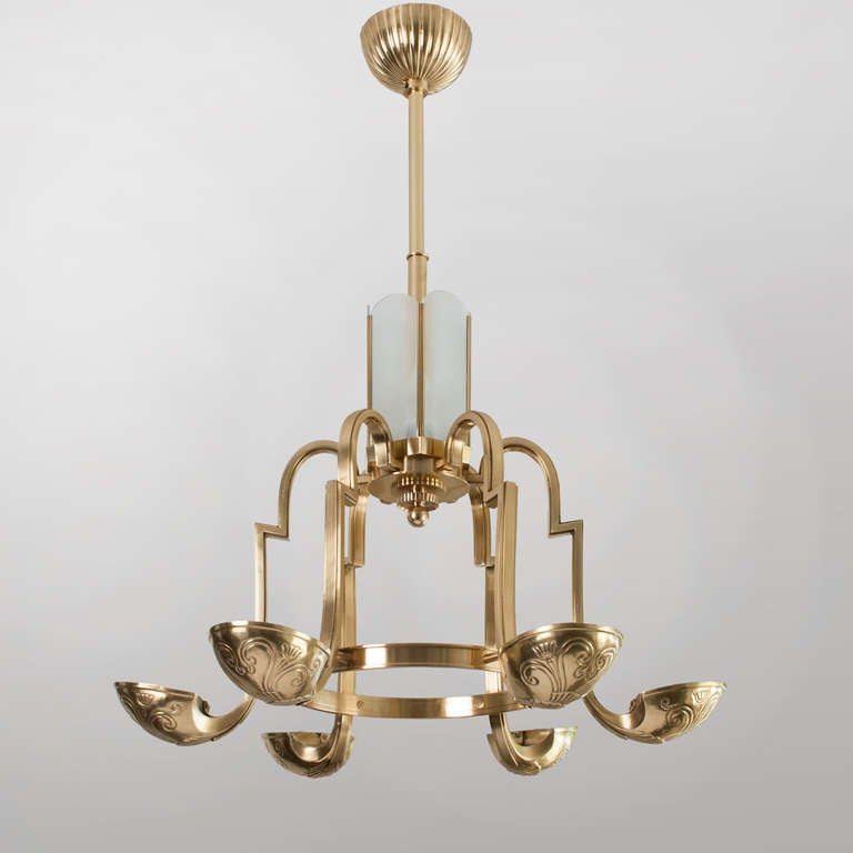 Swedish Art Deco polished brass, 6-arm chandelier with hammered brass shades providing upward light. 6 glass shade panels surround a center element which holds 3 additional lights. Newly restored, polished and lacquered brass, rewired with 9
