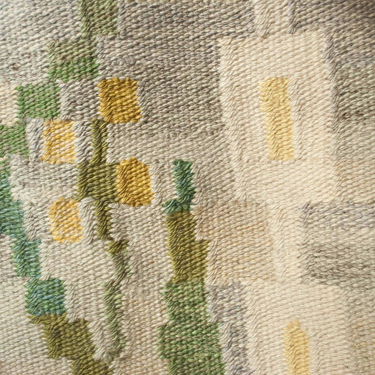 Woven Swedish mid-century wool flat weave rug with yellow flowers on heathered ground.