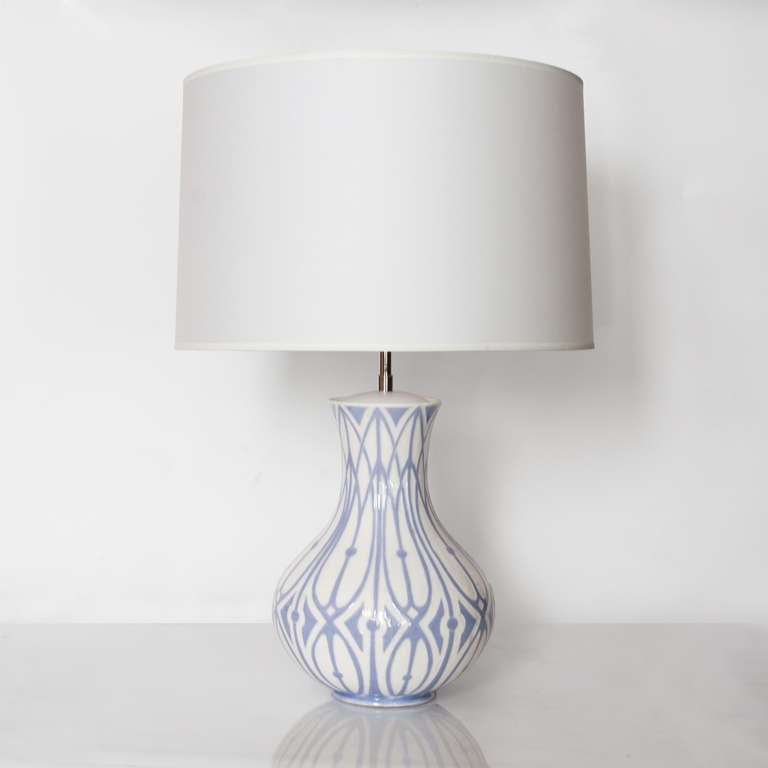 Scandinavian modern ceramic table lamp with a raised designed in blue-violet on a cream glazed ground. An early example of Ekberg's during his time as director of Gustavsberg. Newly rewired with a double socket cluster in nickel. Total height 26