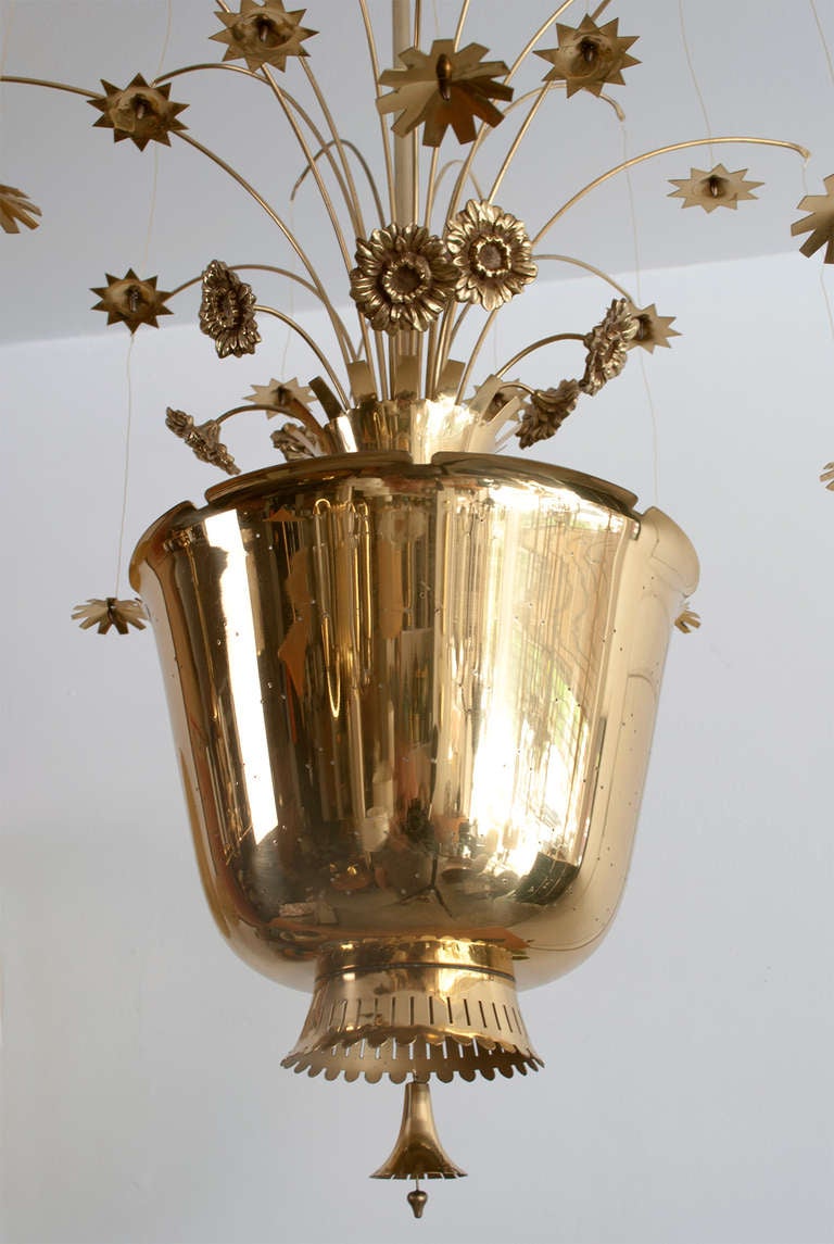 Finnish Paavo Tynell chandelier of pierced brass, with cast and formed brass flowers