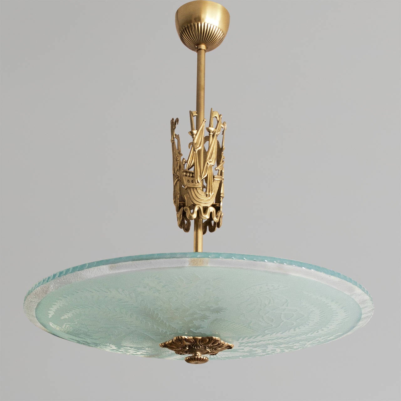 Scandinavian Modern etched glass fixture by Atelier Torndahl. The glass shade is acid and hand etched with underwater plants and jelly fish. The polished brass stem features 3 stylized ships made of cast brass. Measures: Height: 28