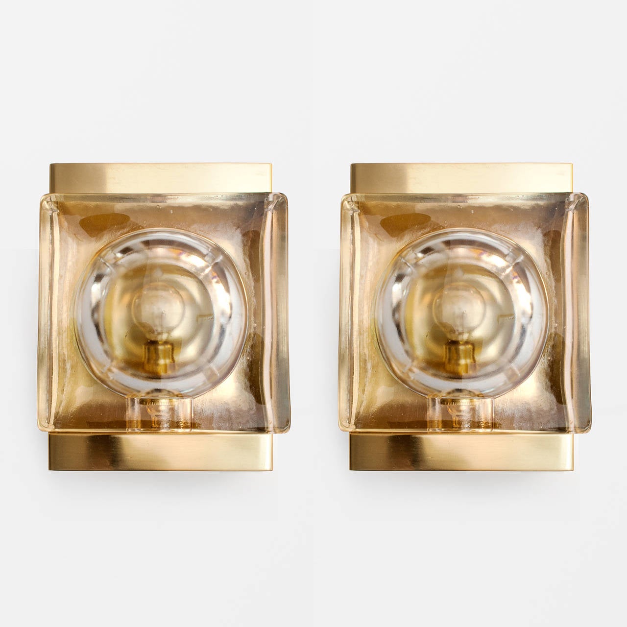 Pair of Danish mid-century modern polished brass sconces with thick molded glass elements. Made by Vitrika. Newly polished and lacquered, new brass candelabra sockets for use in the USA, ready to mount to a standard wall junction box. A second pair