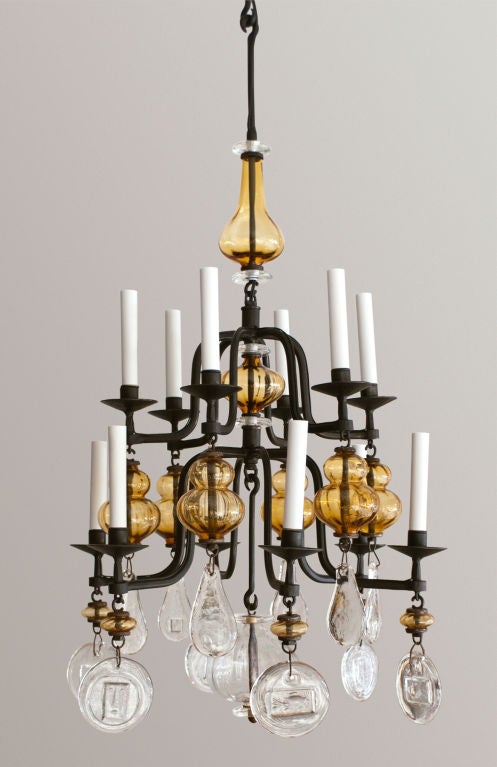 Rare Swedish 12 arm chandelier with hand wrought iron frame with amber and clear glass. Designed by Erik Hoglund for Boda Nova Glassworks/Axel Stromberg Ironwork, Sweden circa 1960's, newly electirfied. Fixture has 3 extension rods (each 7