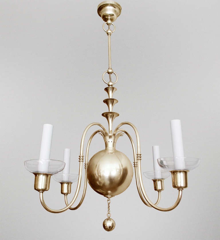 A fantastic 4-arm polished brass Swedish Art Deco chandelier designed by Elis Bergh for C. G. Hallberg, Stockholm, Sweden circa 1920's. The four arched arms sprout from a crown which rest on a large center sphere. A stylized fountain joins a stem