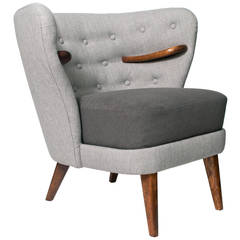 Scandinavian Modern wrap wing chair with internal carved wood arms.