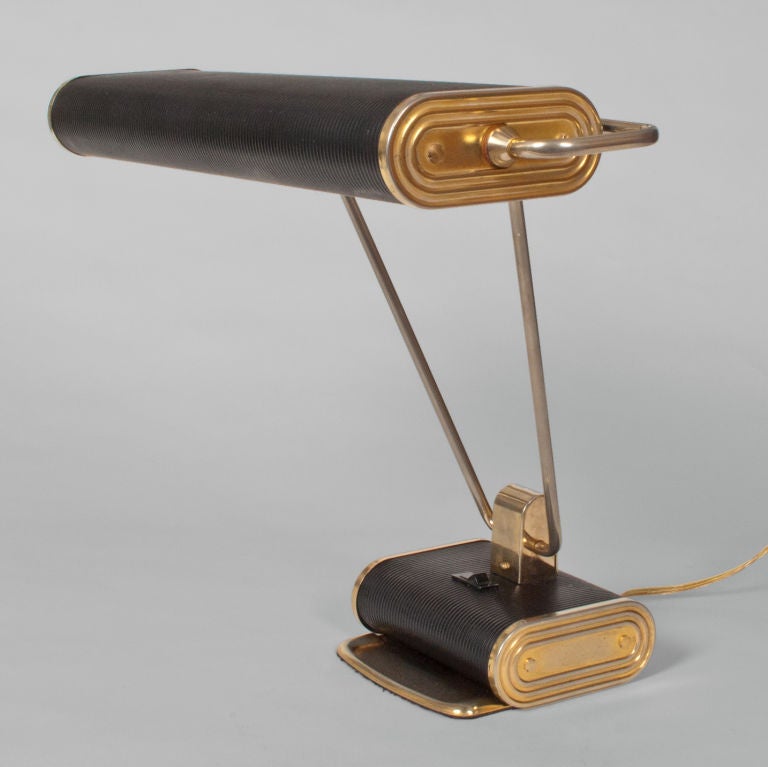 Original French art deco Eileen Gray desk lamp for Jumbo. Black lacquered body with detail in gilded brass, some loss to gold. Newly restored, rewired with 2 standard base sockets. Max Height 15