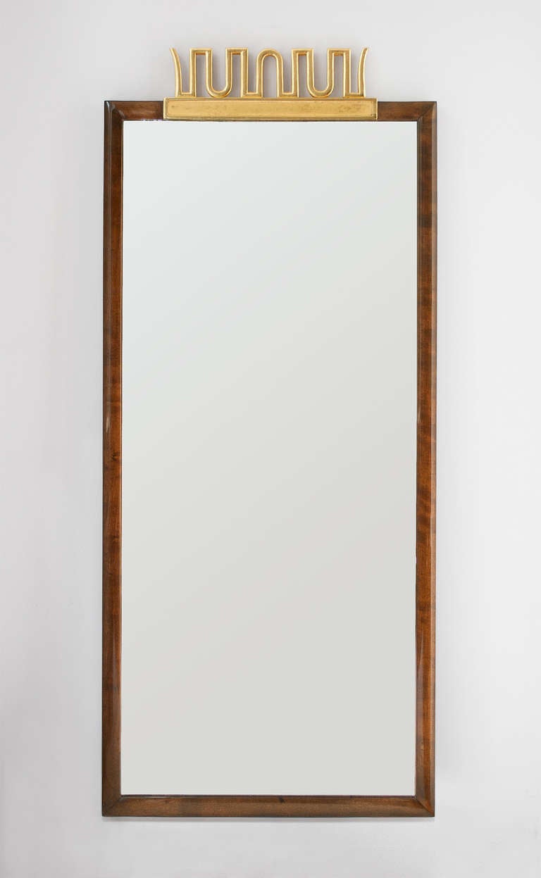 Elegant Swedish Art Deco mirror by Axel Einar Hjorth for NK (Nordiska Kompaniet) Stockholm circa 1920's. The frame is stained and polished birch with a gilt wood carved 