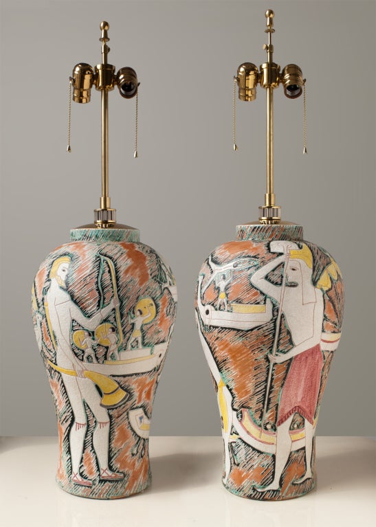 Big fabulous pair of mid-century ceramic table lamps by Marcello Fantoni depicting figures from antiquity. Lamps are unique hand built, richly glazed in creamy white, black, light yellows and reds on a terra-cotta background. The lamp bases are not