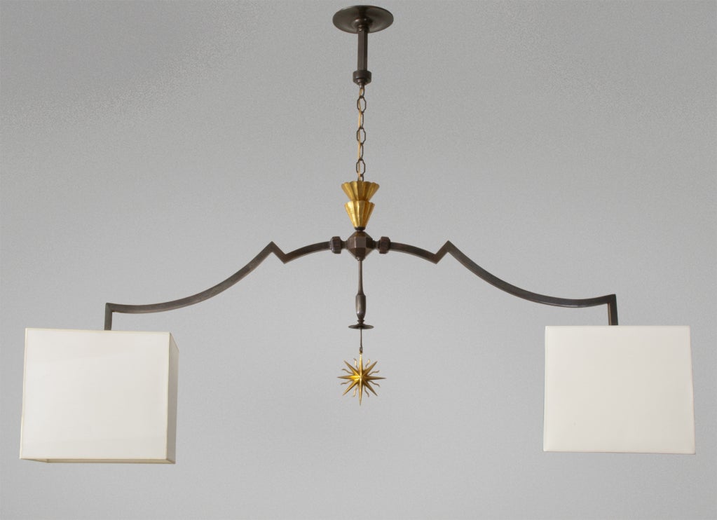 Large spectacular Swedish art deco 2-arm chandelier in bronze with gilded details. Finely detailed chandelier in patinated bronze is highlighted by gilded fluted cones and a beautifully cast 16 pointed star. Each arm ends with a double socket