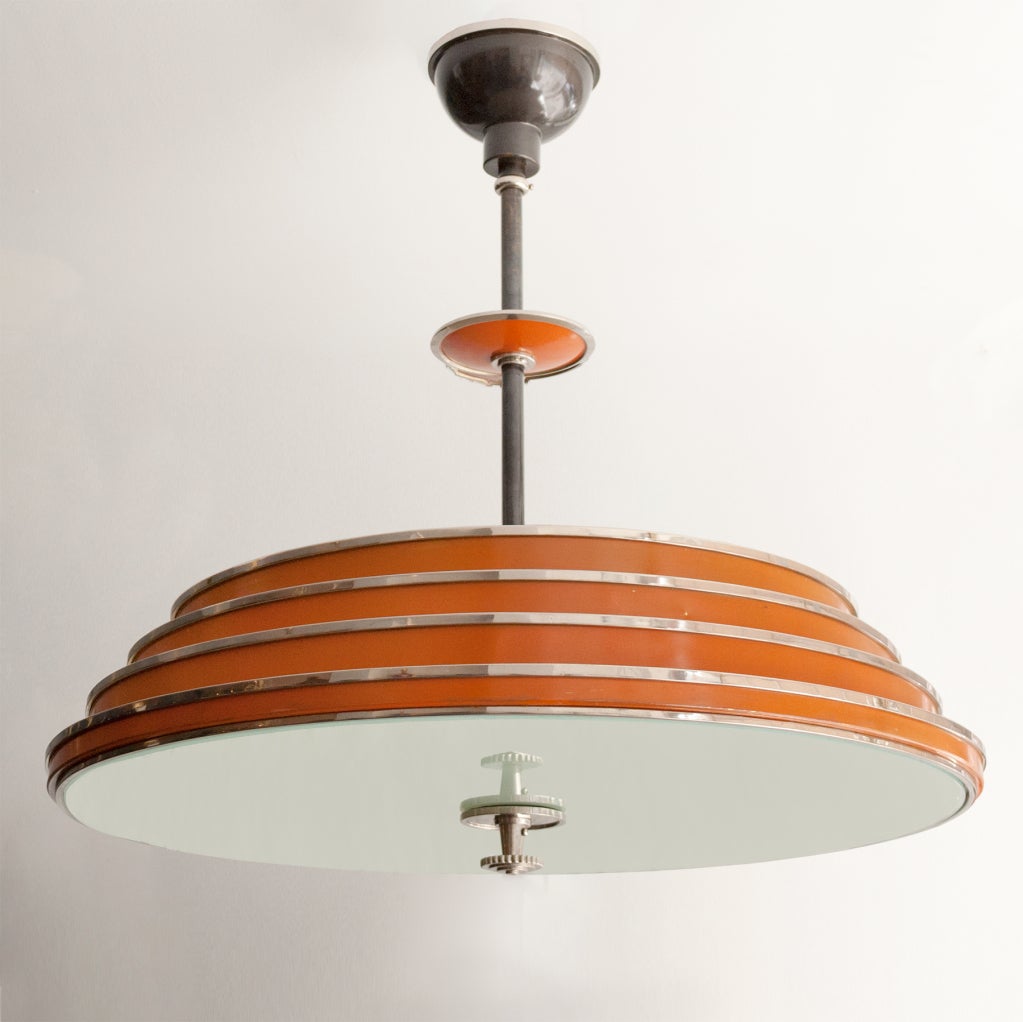 Fine Swedish art deco chandelier by Bohlmarks. The fixture consist of 4 chrome trimmed lacquered rings in a stepped formation. At the bottom is a sandblasted glass shade, there are 6 standard sockets newly electrified for the USA. Chrome details