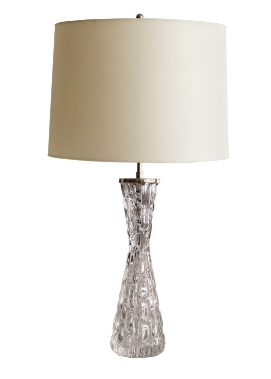 A large Swedish, clear crystal table lamp with nickel plated hardware designed by Carl Fagerlund. The lamp has a stem with double cluster sockets and pulls. Newly rewired, lamp has original paper labels and engraved on bottom and stamped. Body H:16