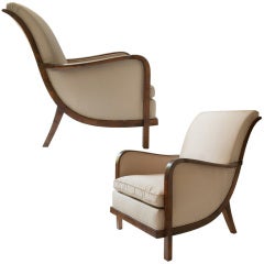 Elegant pair of Swedish Art Deco armchairs with scroll back.