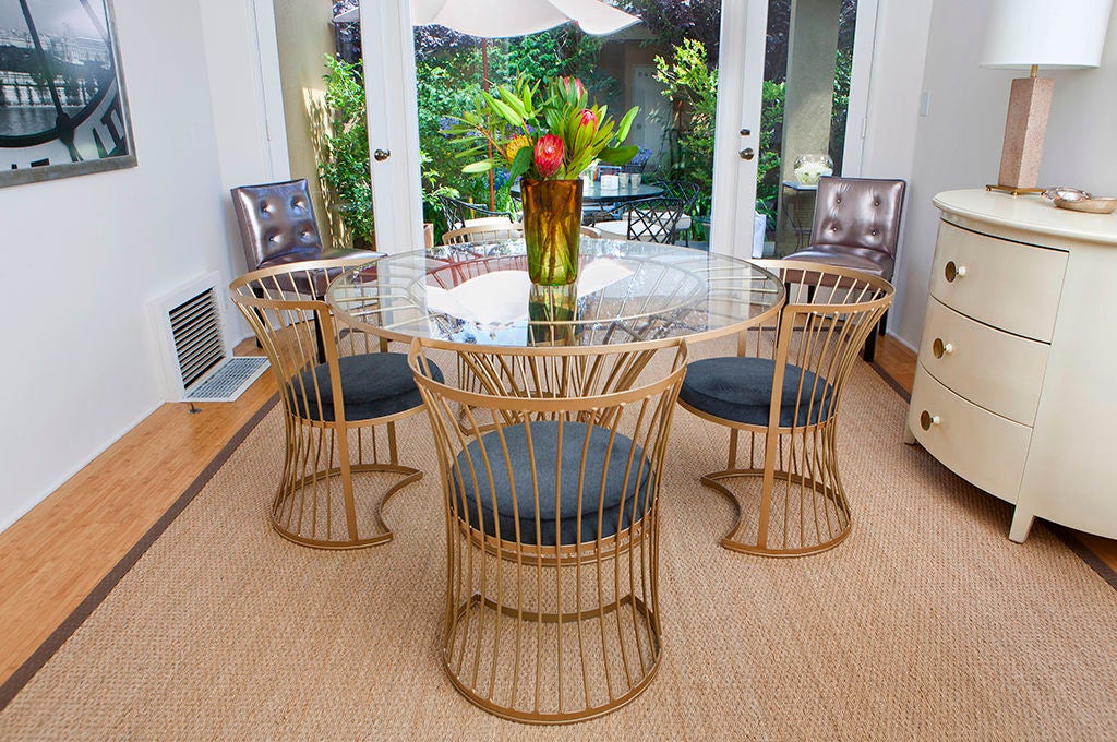 Four dining chairs with newly upholstered, incredibly soft Sumbrella seats cantilever over their half-moon bases, allowing for a fantastic silhouette, in addition to uber comfortable seating. The chairs each measure nearly 29