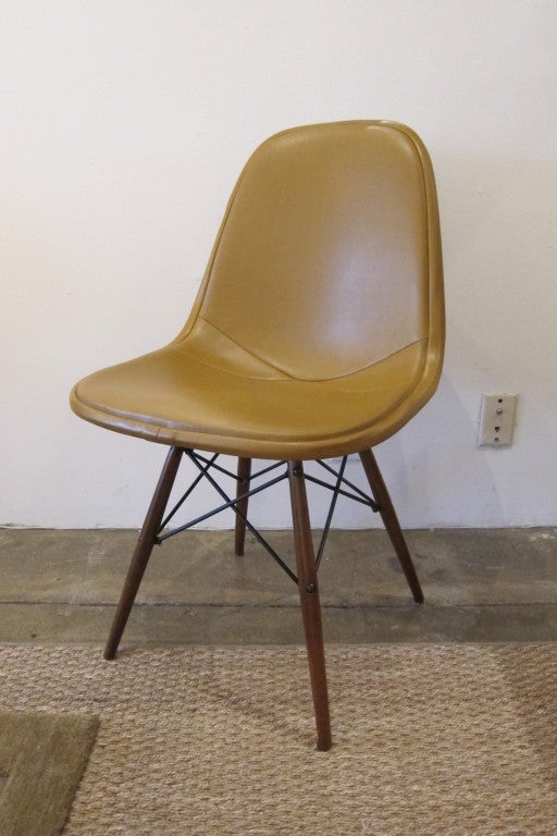 Each of these gorgeous Eames full upholstered metal frame chairs sit atop a newly refinished dowel leg base. Each retains the original caramel leather. Truly an exquisite pair!