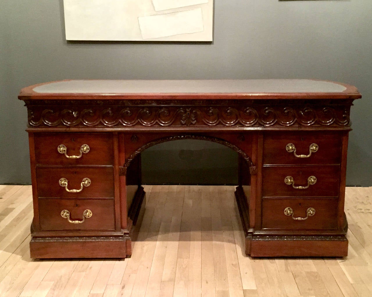 Georgian mahogany library table.
Carved vetruvian scroll detail.
Top now covered in blue/grey felt. 
Kneel hole height 22.5 inches.