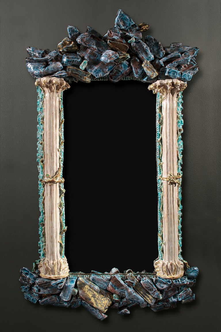 Rocaille parcel-gilt and copper glazed ceramic mirror by Eve Kaplan.

Kaplan’s handmade, earthenware pieces are infused with inspiration from 18th century gilded pieces. They have drawn comparisons to the Mid-Century work of Line Vautrin yet her