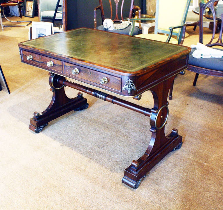 Regency gilt bronze-mounted rosewood trestle writing table.
