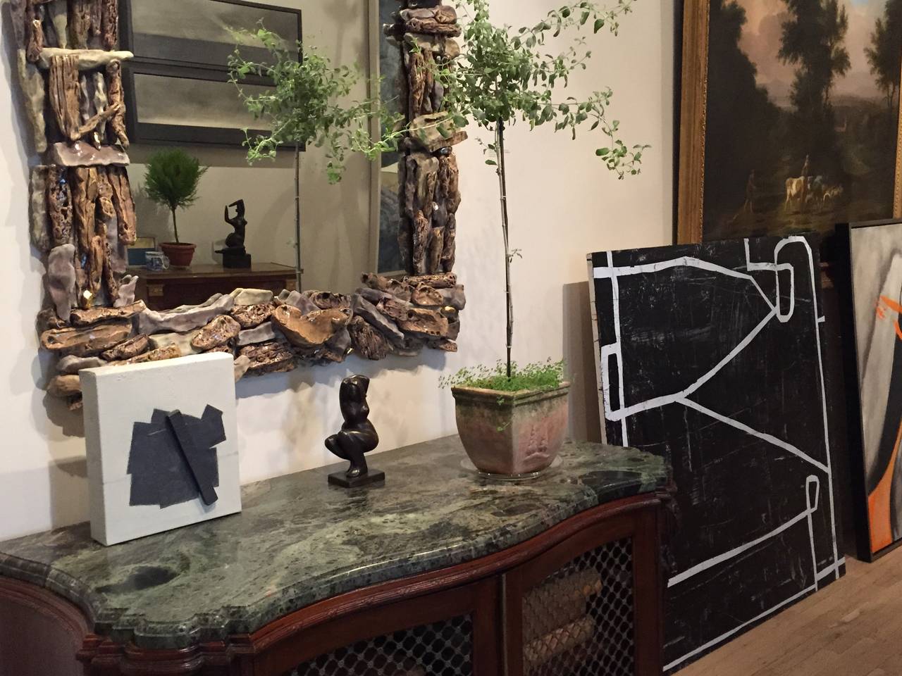 Manganese and chrome glaze ceramic broken pediment mirror by Eve Kaplan
Also available by commission.

Eve Kaplan’s hand built ceramic work is infused with inspiration from 18th century gilded pieces. They have drawn comparisons to the